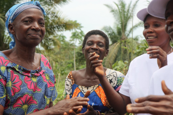 Women singing and dancing at a community meeting in Kananga, DRC